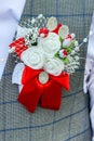 Wedding boutonniere on lapel of jacket of groom best man. Royalty Free Stock Photo