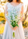 Wedding bridal bouquet of blue Delphinium in the hands of the br Royalty Free Stock Photo