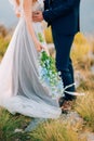 Wedding bridal bouquet of blue Delphinium in the hands of the br Royalty Free Stock Photo