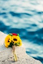 Wedding bridal bouquet of sunflowers on the dock near the sea. W Royalty Free Stock Photo