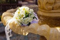 The Wedding Bridal Bouquet Of White Roses Lies In An Old Fountain Under Splashes And Drops Of Water. Royalty Free Stock Photo