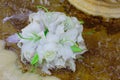 The Wedding Bridal Bouquet Of White Roses Lies In An Old Fountain Under Splashes And Drops Of Water. Royalty Free Stock Photo