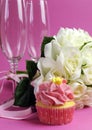 Wedding bridal bouquet of white roses on pink background with cupcake Royalty Free Stock Photo