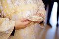 Wedding of the bride and groom. The priest holds in his hands a gold plate with wedding rings. Church glans Royalty Free Stock Photo