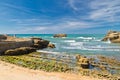 Wedding of bride and groom standing on rock on scenic colorful atlantic coast in blue sky in biarritz, basque country, france Royalty Free Stock Photo