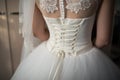 Wedding, the bride wore a white dress and now she is laced with a corset Royalty Free Stock Photo