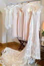Wedding and bridesmaids dresses hanging on a metal hanger