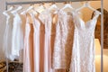 Wedding and bridesmaids dresses hanging on a metal hanger