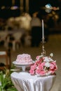 Wedding cake in beach wedding. beautiful pink wedding cake. white vintage wedding cake on wooden table Royalty Free Stock Photo