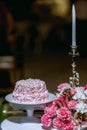 Wedding cake in beach wedding. beautiful pink wedding cake. white vintage wedding cake on wooden table Royalty Free Stock Photo