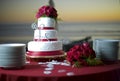 Wedding Cake at the Beach and the Ocean Behind Royalty Free Stock Photo