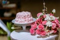 Wedding cake in beach wedding. beautiful pink wedding cake. white vintage wedding cake on wooden table Royalty Free Stock Photo