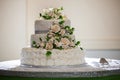 wedding cake close-up photo of a beautiful white three-tiered wedding cake decorated by flowers and greenery bakery Royalty Free Stock Photo