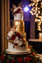 Wedding cake decorated with a beautiful gold decor of cream Royalty Free Stock Photo