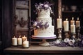 Wedding cake decorated with flowers and candles on the table. Royalty Free Stock Photo