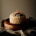 Wedding cake decorated with flowers on a wooden plate, homemade cream pastry, sweet rustic dessert, generative ai Royalty Free Stock Photo