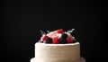 wedding cake with fresh berries on a black background, close-up Royalty Free Stock Photo