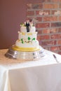 A wedding cake with gold ribbon