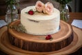 wedding cake with monogrammed icing on wooden board Royalty Free Stock Photo