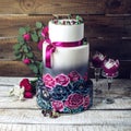 Wedding cake ornamented in rustic style blue and purple roses