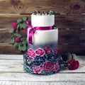 Wedding cake ornamented in rustic style blue and purple roses