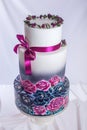 Wedding cake ornamented in rustic style blue and purple roses