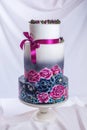 Wedding cake ornamented in rustic style blue and purple roses