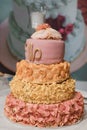 Wedding cake with pink frosting and a flowers on top Royalty Free Stock Photo