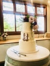 A wedding cake, with topper sign of Chinese character golden double happiness.