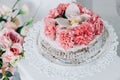 Wedding cake on a white pedestal decorated with fresh flowers Royalty Free Stock Photo