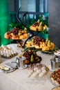 Wedding. Candy bar. On the buffet table there are glasses with drinks, fruits and different sweets Royalty Free Stock Photo