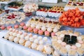 Wedding candy bar with different colored bright cupcakes, macaroons, cakes, jelly and fruits. Royalty Free Stock Photo