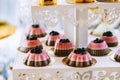 Wedding candy bar with different colored bright cupcakes, macaroons, cakes, jelly and fruits Royalty Free Stock Photo