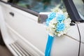 Wedding car with beautiful decorations. Close up white and cyan flowers roses on newlyweds car Royalty Free Stock Photo