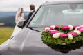 Wedding car with bride and groom in the background Royalty Free Stock Photo