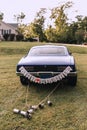 The wedding car with just married sign and cans tied to the trunk Royalty Free Stock Photo