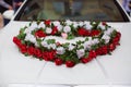 Wedding car and petals on top. Luxury wedding car decorated with flowers.just married sign and cans attached. Heart roses Royalty Free Stock Photo