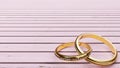 Wedding card - pink background and two golden rings joined together forever with words `All my love`, that symbolize devotion Royalty Free Stock Photo