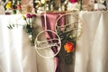 Wedding celebration table decoration. Wooden rings with lettering groom and bride. Flowers in glass vases. Wedding day Royalty Free Stock Photo