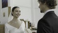 The wedding ceremony. Action.A huge hall with chairs where a young groom in a suit and a bride in a long white dress