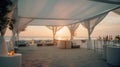 wedding ceremony banquet in white chalet at the sea and sunset sun on the background. Generative AI Royalty Free Stock Photo
