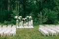wedding ceremony in a beautiful garden. white chairs and mirrored tables. Glass vase with flowers calla lilies amaryllis Royalty Free Stock Photo