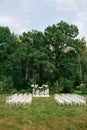 wedding ceremony in a beautiful garden. white chairs and mirrored tables. Glass vase with flowers calla lilies amaryllis Royalty Free Stock Photo