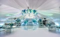 Wedding ceremony in a beautiful tent. Hall with dining tables decorated with bouquets of flowers. Royalty Free Stock Photo