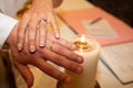 Wedding ceremony candle with bride and groom hands and rings Royalty Free Stock Photo