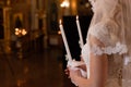 wedding ceremony. Church wedding. The bride is holding candles. White dress