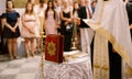 Wedding ceremony in an Orthodox church. The priest in a white cassock stand in the church at the altar, candles and