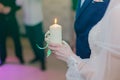 Wedding ceremony, paraphernalia, the bride and groom hold a large candle in their hand Royalty Free Stock Photo