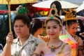 Wedding ceremony on the street. Young attractive Thai women in traditional dresses and jewelry are smiling cute next to an unimpr