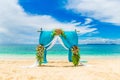 Wedding ceremony on a tropical beach in blue. Arch decorated wit